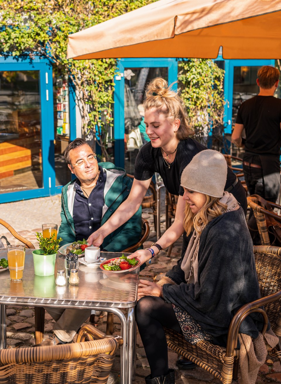 Ein Paar wird am Tisch bedient und bekommt einen Vorspeisenteller. // Die Likörfabrik in Rostock hat eine Terrasse, die auch noch im Herbst wunderbar sonnig ist // © MV-T/Tiemann Ein Paar wird am Tisch bedient und bekommt einen Vorspeisenteller.