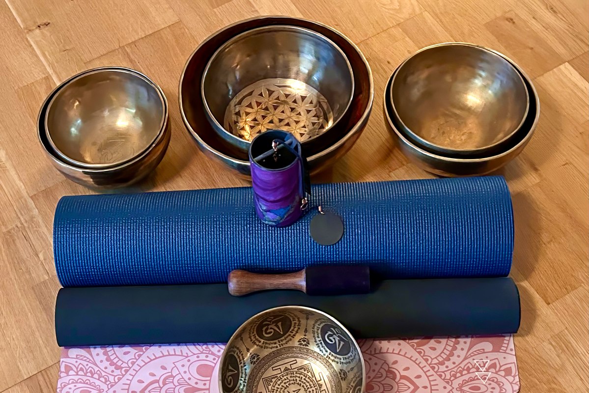 Setup für eine heilsame Auszeit: Traditionelle Klangschalen und sanfte Klangspiele stehen auf blauen Yogamatten bereit für die nächste meditative Chakren-Klangreise. Vorbereitung für tiefe Entspannung und Harmonisierung der Energiezentren. // © Sandra Dethier Setup für eine heilsame Auszeit: Traditionelle Klangschalen und sanfte Klangspiele stehen auf blauen Yogamatten bereit für die nächste meditative Chakren-Klangreise. Vorbereitung für tiefe Entspannung und Harmonisierung der Energiezentren. // © Sandra Dethier