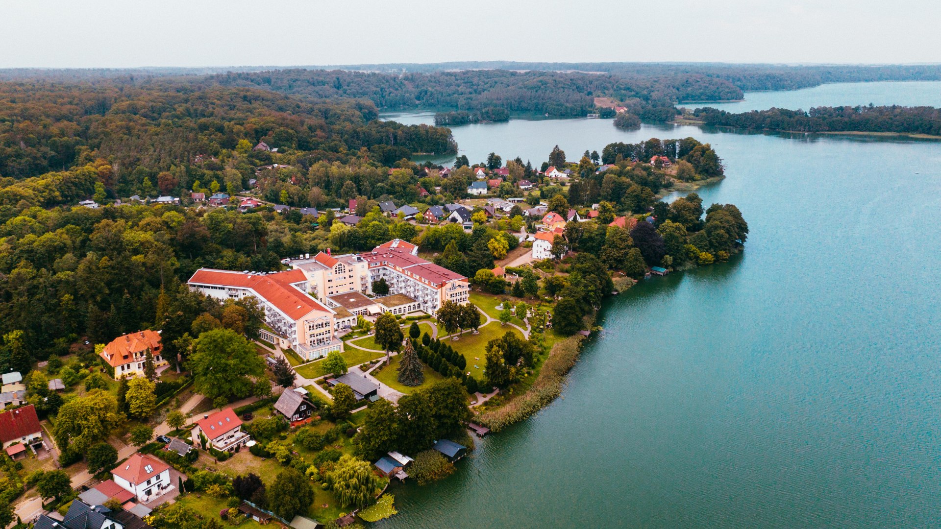 Die Klinik am Haussee liegt idyllisch und ruhig in der Feldberger Seenlandschaft und bietet Erholung pur., © TMV/Friedrich Das Medical Wellness Zentrum Feldberger Seenlandschaft liegt direkt am See und ist aus der Luft zu sehen.