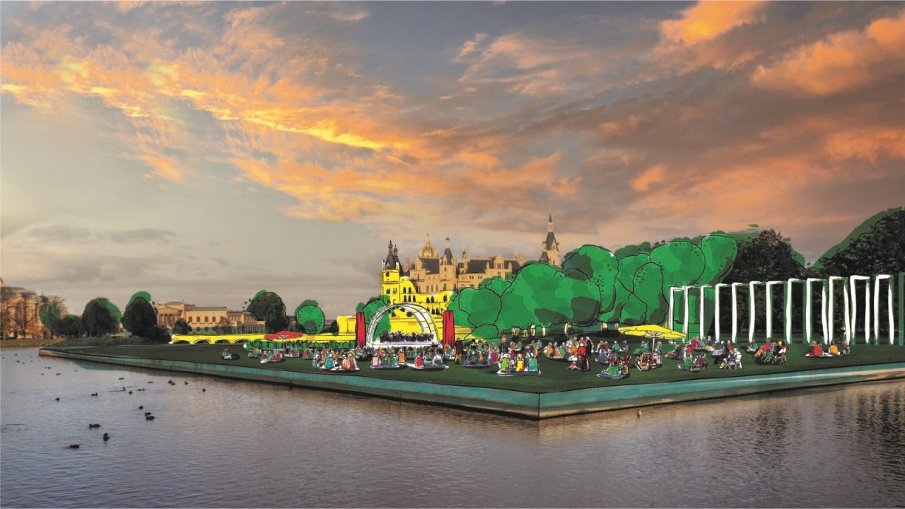 Eine Visualisierung der Schlossfestspiele auf der Schwimmenden Wiese in Schwerin in Sichtweite des Schweriner Schlosses. // © Mecklenburgisches Staatstheater Eine Visualisierung der Schlossfestspiele auf der Schwimmenden Wiese in Schwerin in Sichtweite des Schweriner Schlosses. // © Mecklenburgisches Staatstheater