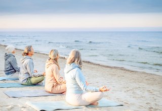 Meditation am Strand | Symbolfoto // &copy; Adobe Firefly (KI-generiert)