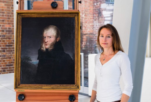 Auch Katrin Staude hat gemalt und sogar ausgestellt., © TMV/Tiemann Katrin Staude vor dem Portrait von Caspar David Friedrich