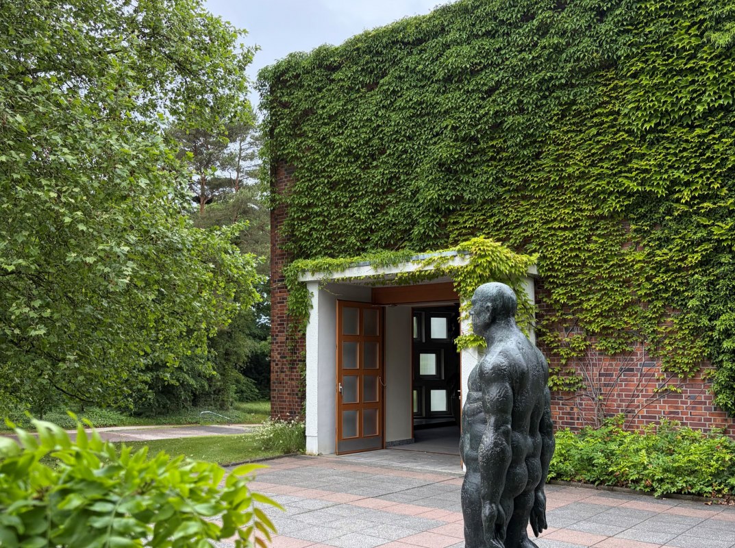 Uitgang naar de rouwhal Waldfriedhof en sculptuur "Schreitender" van Wieland Förster // © SDS Uitgang naar de rouwhal Waldfriedhof en sculptuur "Schreitender" van Wieland Förster // © SDS