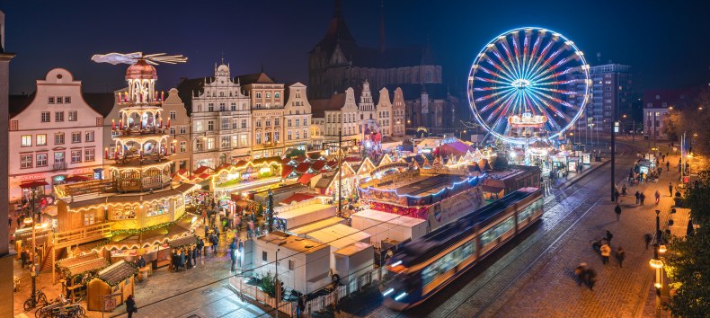 Lichterglanz und festliche Stimmung – der Rostocker Weihnachtsmarkt begeistert mit historischen Fassaden, duftenden Leckereien und einem leuchtenden Riesenrad mitten in der Altstadt., © Erik Gross