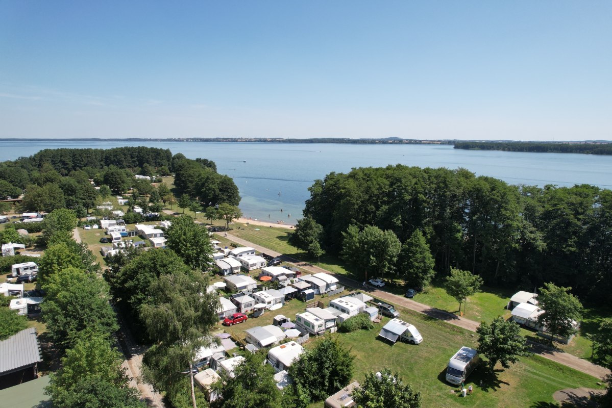 Een luchtfoto van vakantiepark Seehofs, dat direct aan het Schweriner Meer ligt. De foto is genomen tijdens het hoogseizoen in de zomer, toen veel gasten bij ons een pauze zochten om tot rust te komen en te ontspannen. // &copy; BVCD e.V.