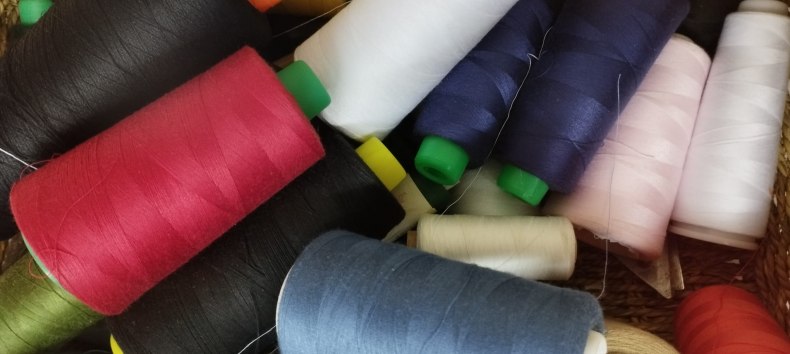 Ein Korb voller verschieden farbiger N&auml;hgarnspulen. // &copy; Jugendkunstschule Vorpommern-R&uuml;gen e.V.