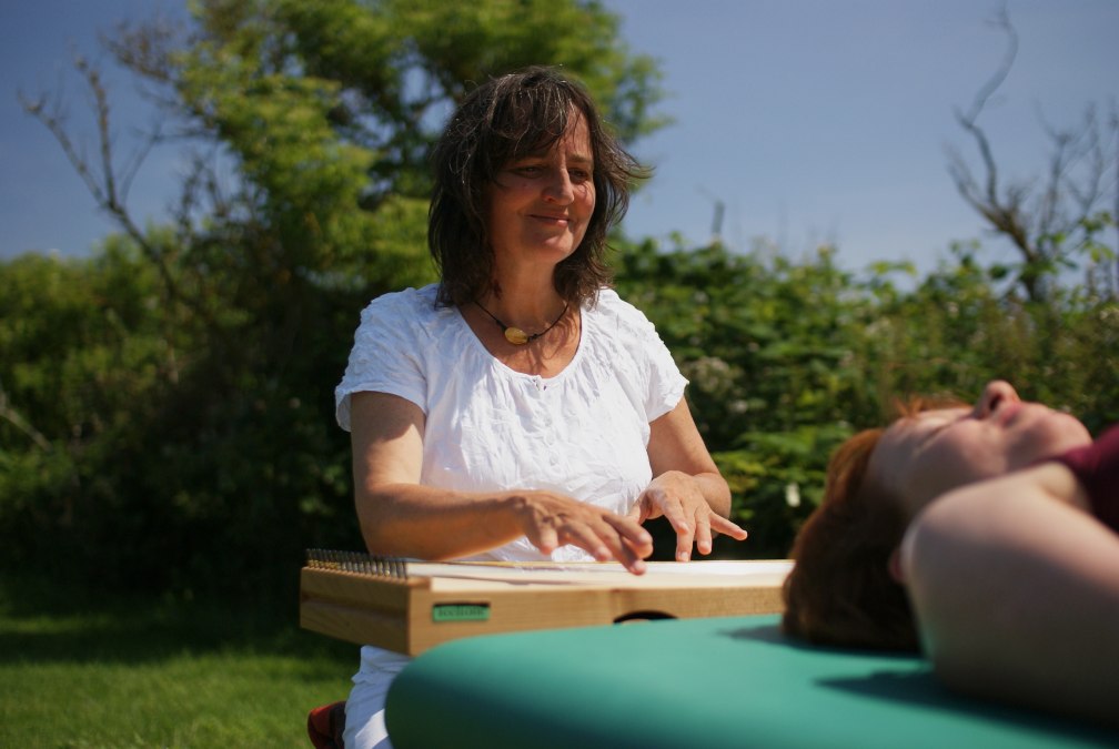 Martina Gläser-Böhme spielend am Monochord - auf der Liege eine Klientin, © Martina Gläser-Böhme